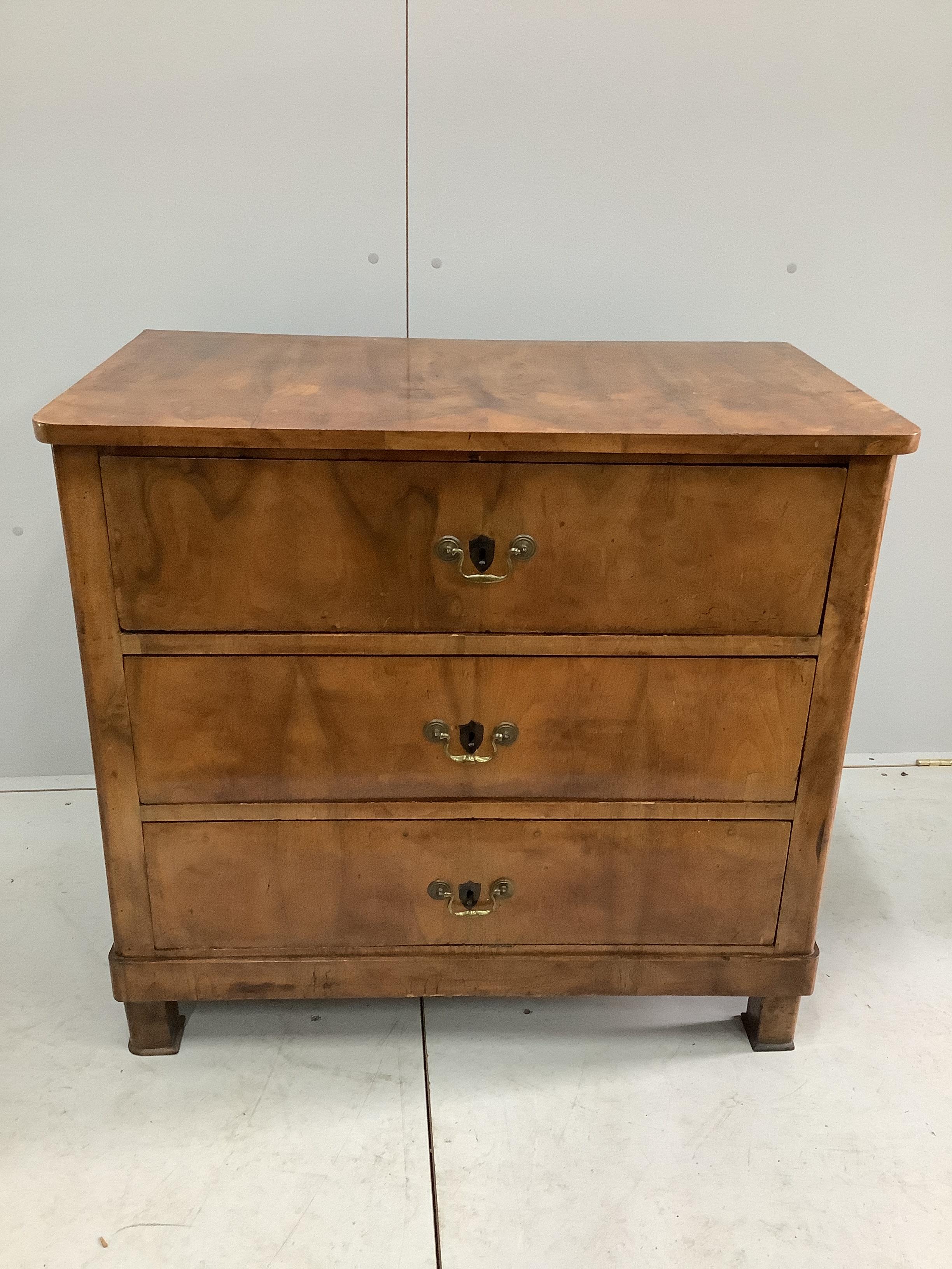 An early 19th century Continental walnut three drawer chest, width 89cm, depth 52cm, height 82cm